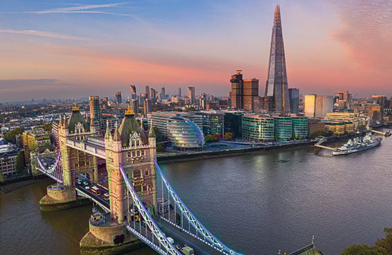 A view of London at sunset, with the Tower Bridge and the Shard in the foreground