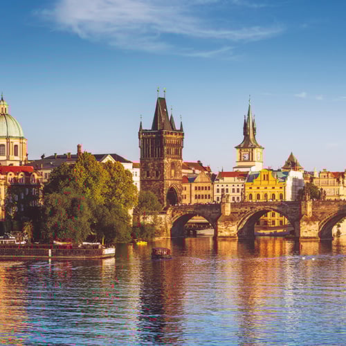A panoramic view of Prague, Czech Republic, featuring the iconic Charles Bridge and the historic Old Town