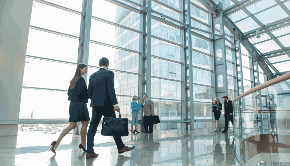 Business people walking in modern glass office